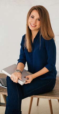 A girl with a grey diary in hand ready to answer Mybizzhive faq